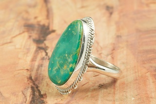 Genuine Manassa Turquoise set in Sterling Silver Ring. This Turquoise is also referred to as King�s Manassa Turquoise. The Manassa Turquoise mine is located in Manassa, Conejos County, Colorado. Created by Navajo Artist Larson Lee. Signed.